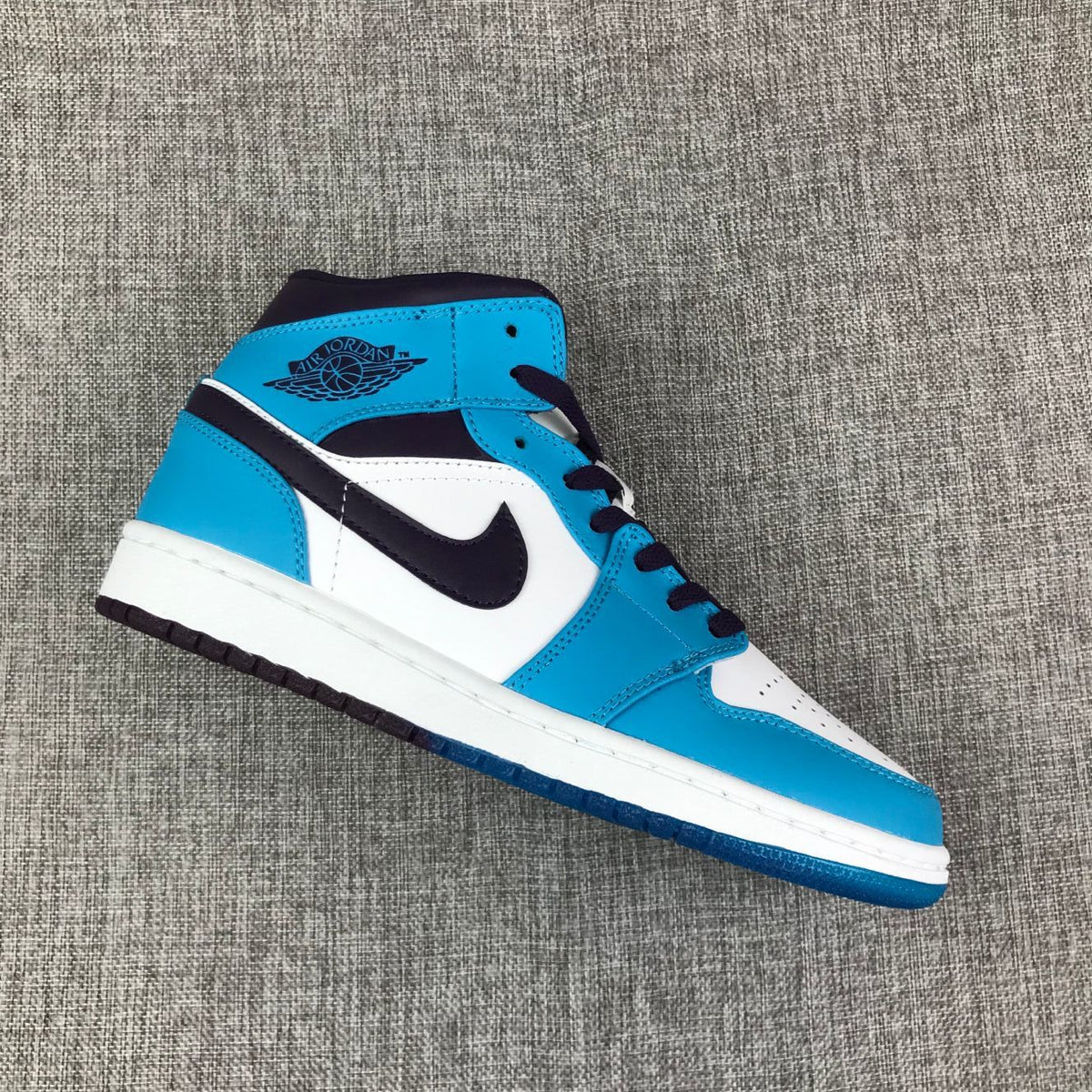 Air Jordan 1 Mid Sneakers in Blue, in White and Black - product image from the listing.