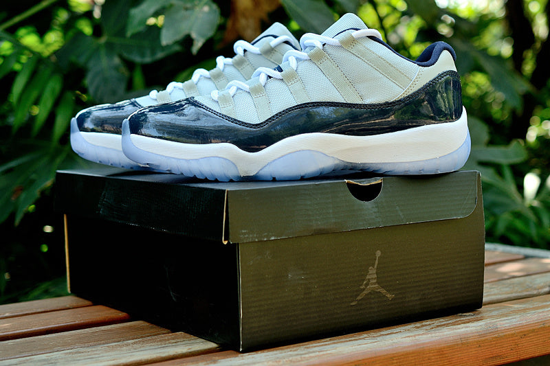 Air Jordan 11 Retro Low Sneakers, White and Navy - product image from the listing.