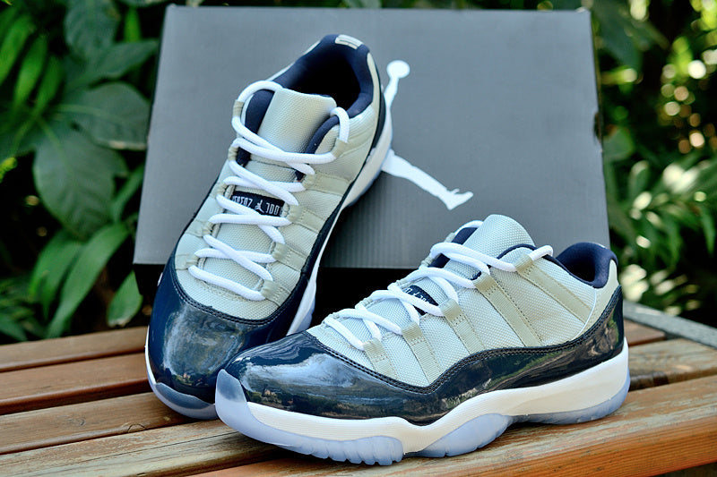 Air Jordan 11 Retro Low Sneakers, White and Navy - product image from the listing.