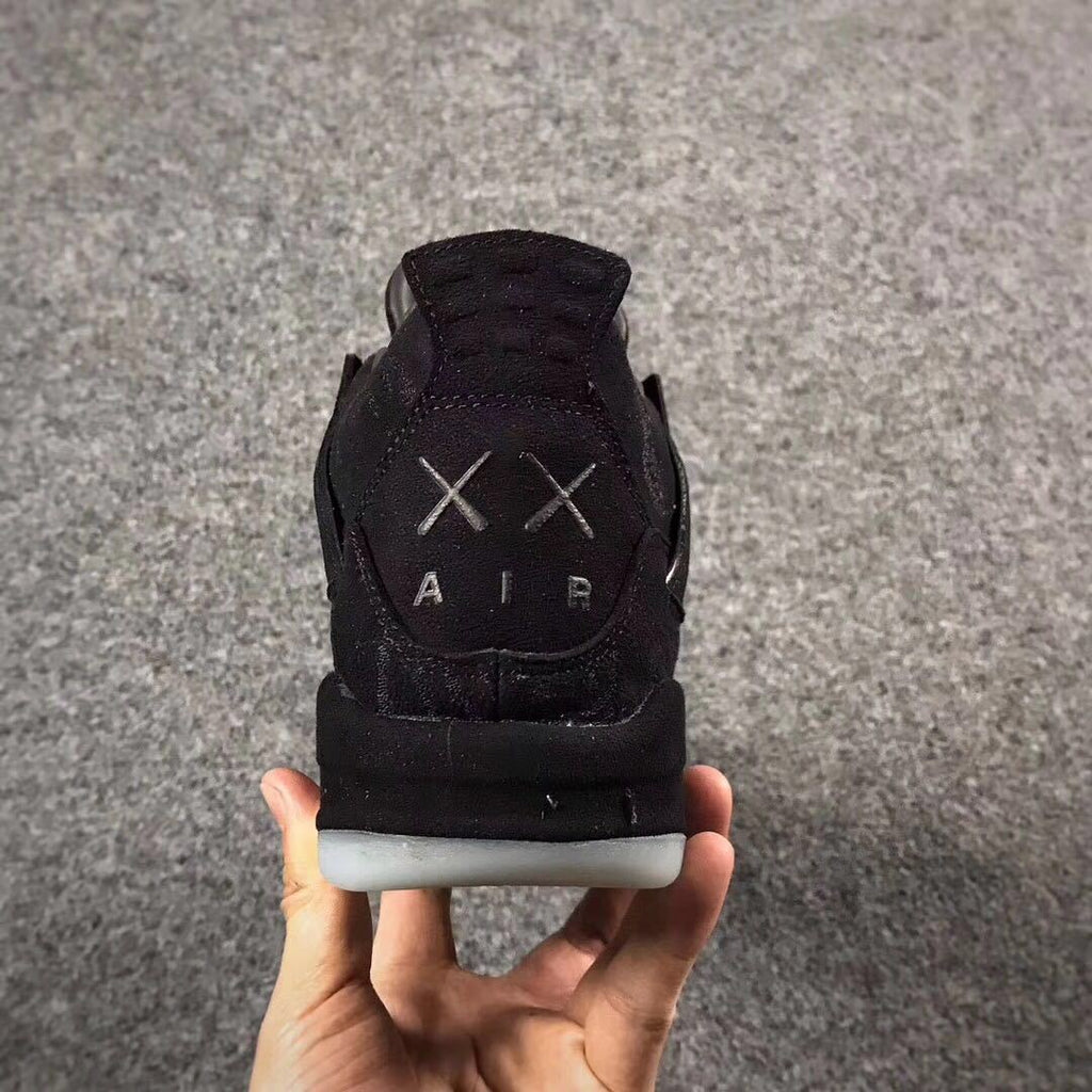 Jordan 4 KAWS Graffiti High-Top Sneakers in Black - product image from the listing.