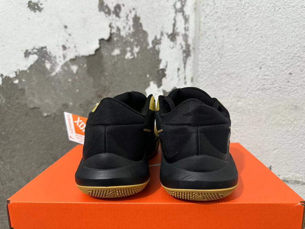 Nike Basketball Sneakers in Black and Gold - product image from the listing.