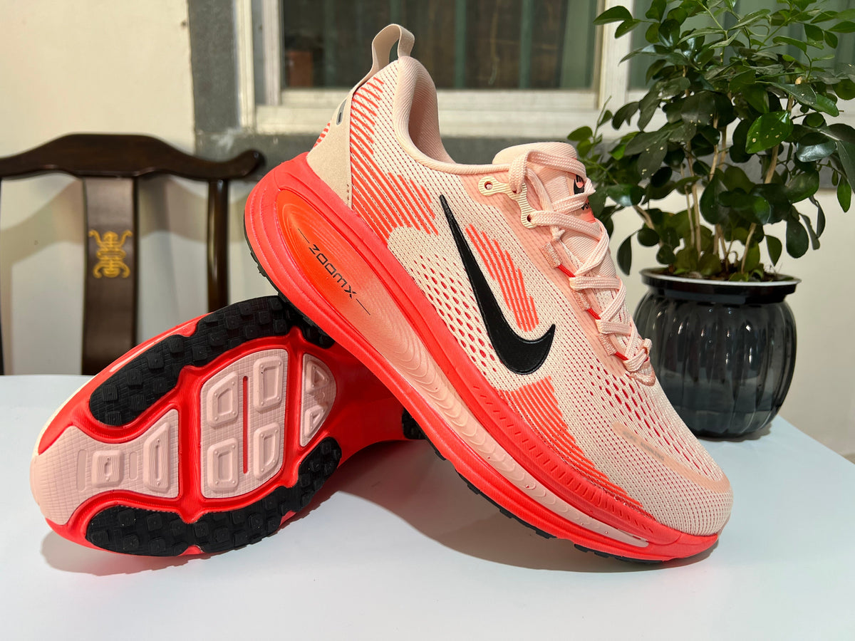 Cream and Coral Nike Vomero 18 Running Shoes - product image from the listing.