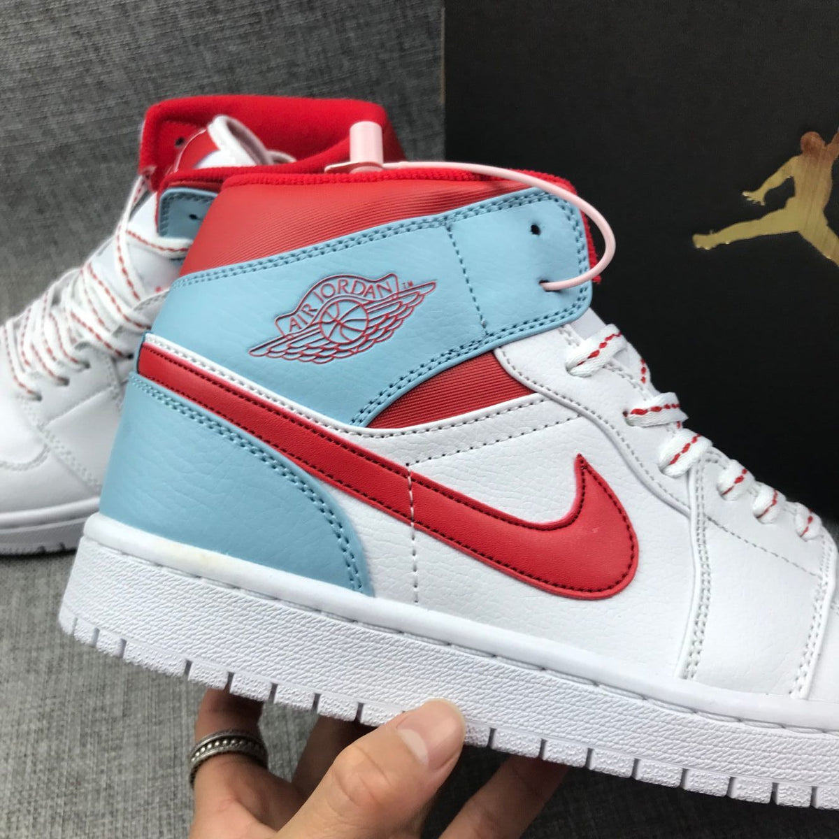 Air Jordan 1 Mid Sneakers in Ice Blue White and Red 555112-104 - product image from the listing.