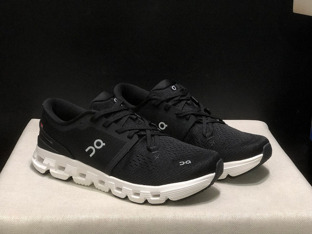 On Cloud X 4 Sneakers in Black and White - product image from the listing.