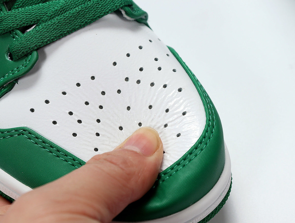 Jordan 1 Low Sneakers in White and Green 553558-301 - product image from the listing.
