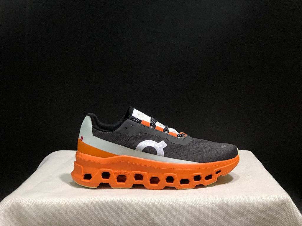 On Cloudmonster Running Shoes in Black Orange - product image from the listing.