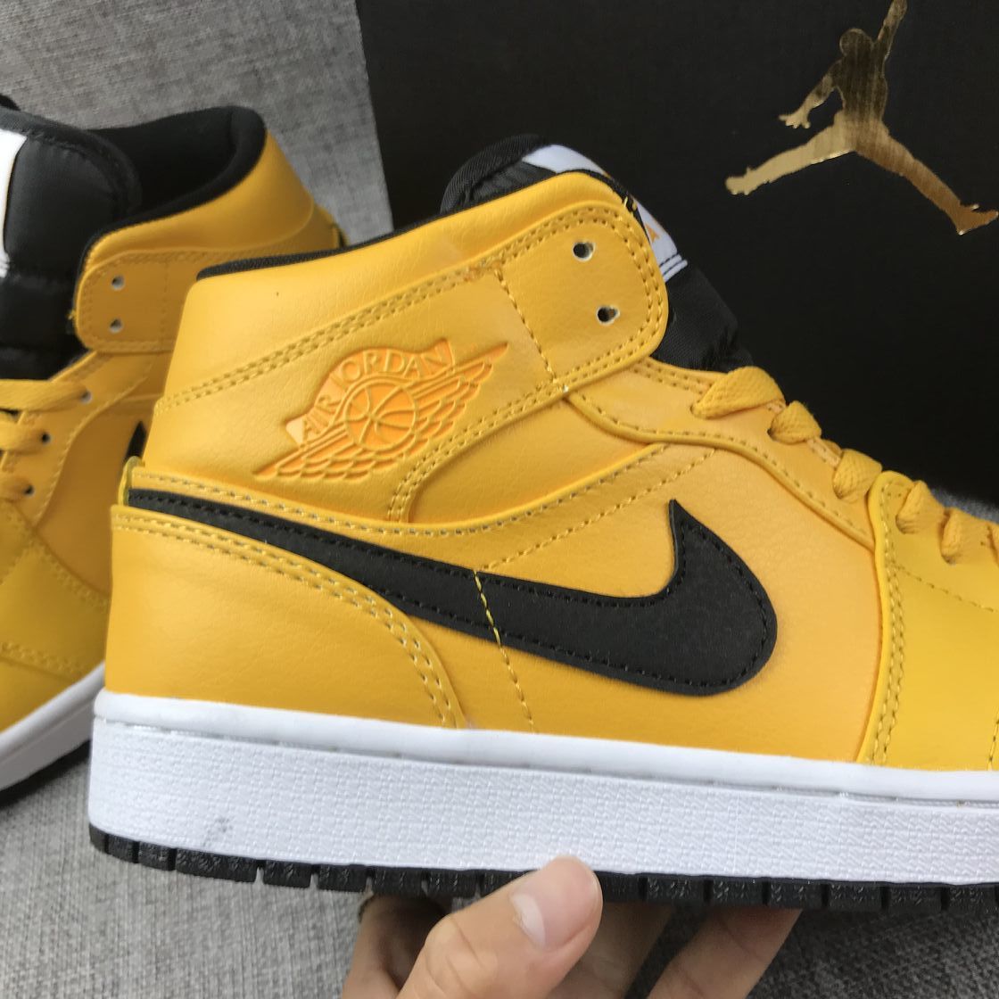 Air Jordan 1 Mid Sneakers in University Gold Black White - product image from the listing.