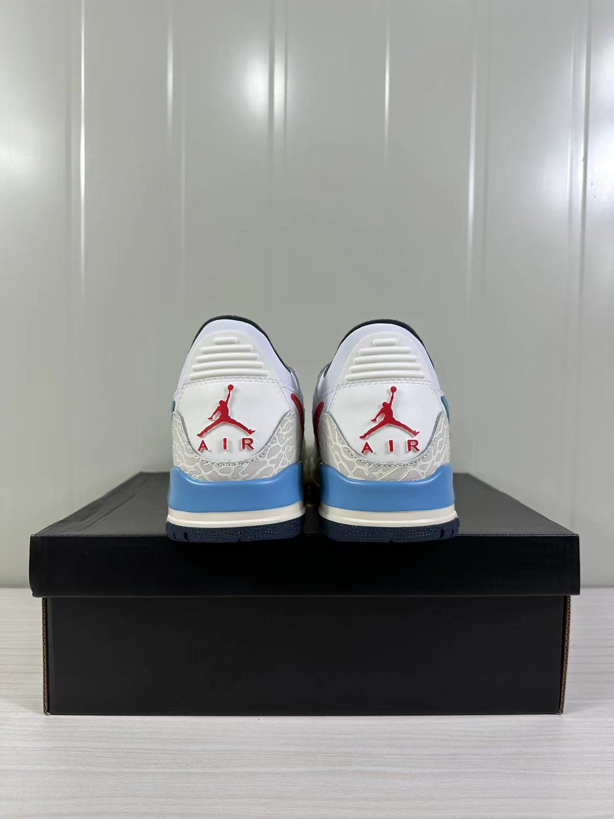 Jordan Legacy 312 Low in White Blue Red HM3709-141 - product image from the listing.