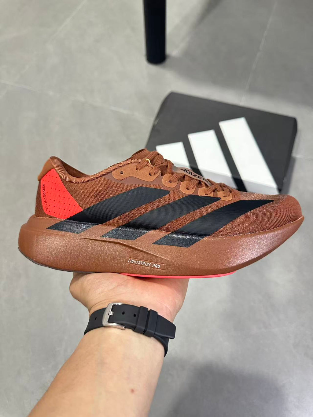 Adizero Lightstrike Pro Running Shoes, in Brown and Black KJ8809 - product image from the listing.