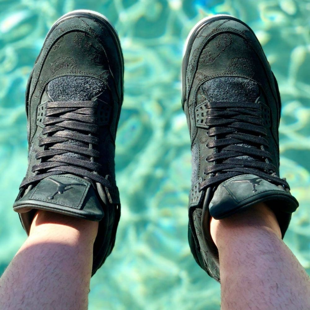 Air Jordan 4 Retro X Kaws in Black - product image from the listing.