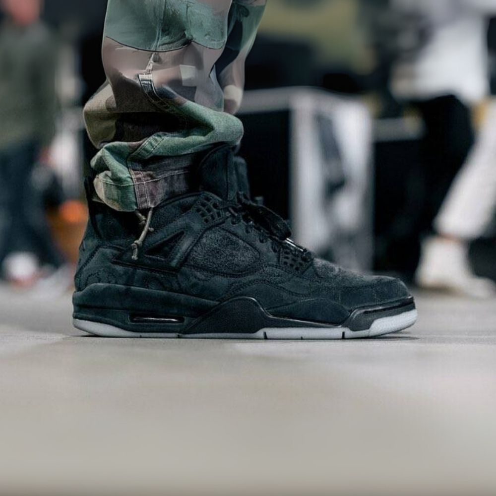 Air Jordan 4 Retro X Kaws in Black - product image from the listing.
