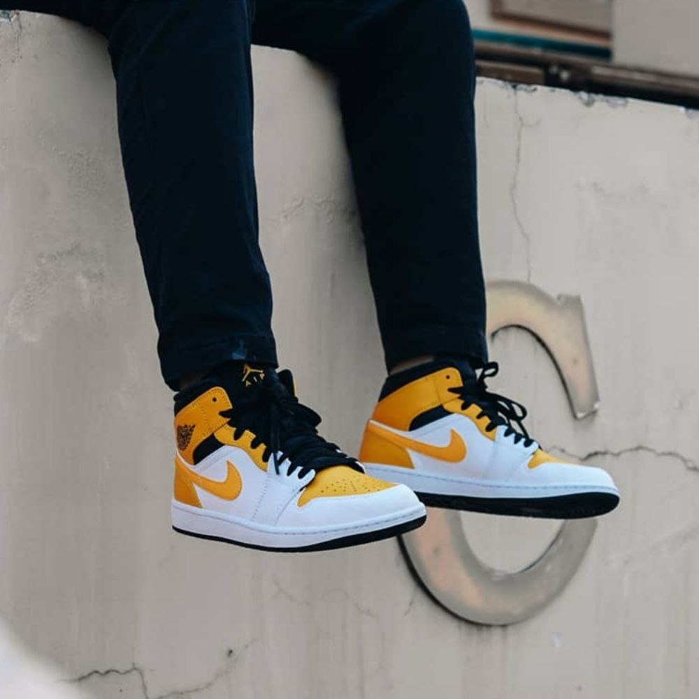 Air Jordan 1 Mid in University Gold White Black - product image from the listing.