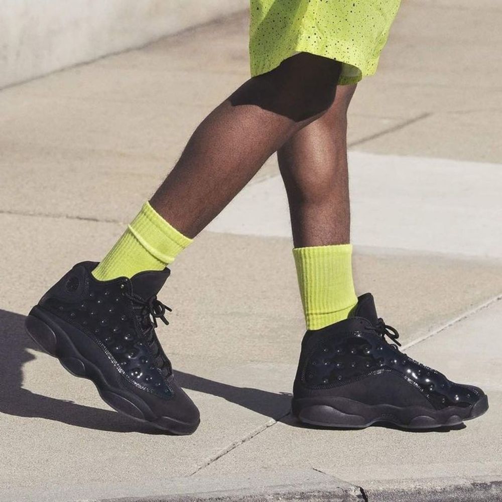 Air Jordan 13 Retro Cap and Gown Triple in Black - product image from the listing.