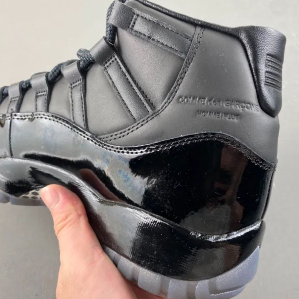 Air Jordan 11 Comme des Garçons Homme Plus in Black - product image from the listing.