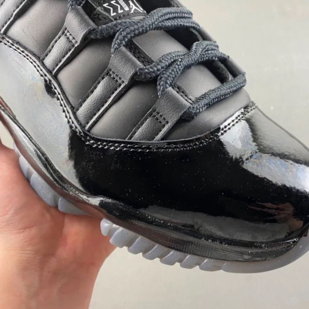 Air Jordan 11 Comme des Garçons Homme Plus in Black - product image from the listing.