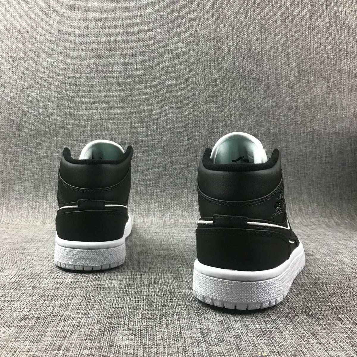 Air Jordan 1 Mid Sneakers in Black and White 852542-016 - product image from the listing.