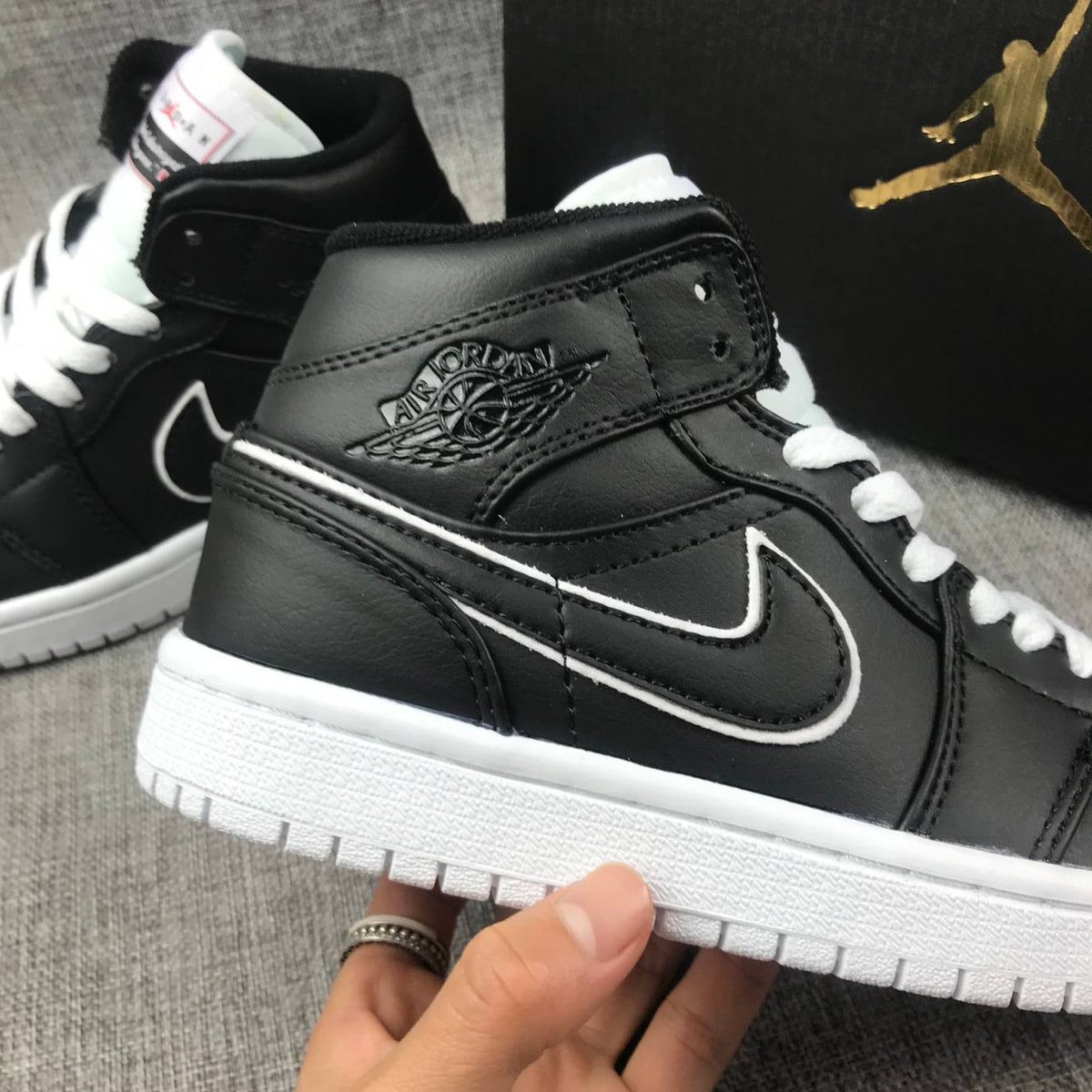 Air Jordan 1 Mid Sneakers in Black and White 852542-016 - product image from the listing.