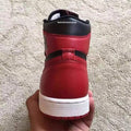 Air Jordan 1 High Sneakers in Black and Red - product image from the listing.