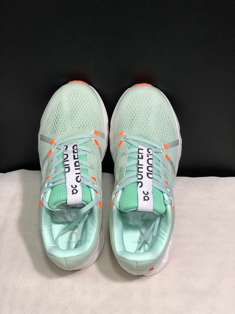 Pale Green and White On Cloudsurfer Sneakers - product image from the listing.