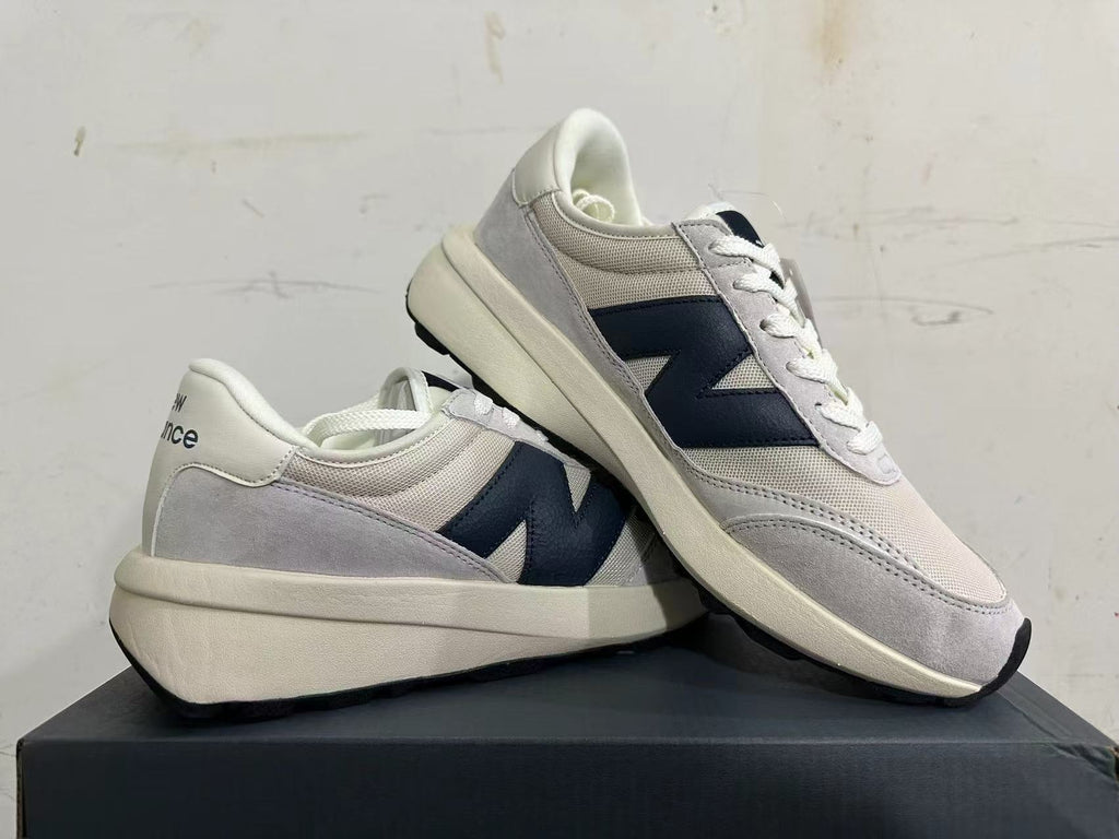 Gray and Navy New Balance U370 Sneakers - product image from the listing.