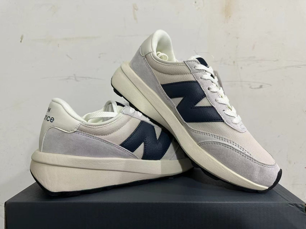 Gray and Navy New Balance U370 Sneakers - product image from the listing.