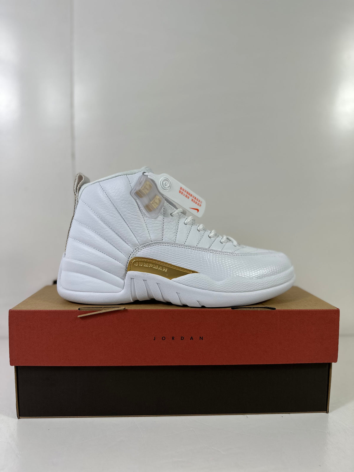 Air Jordan 12 Phantom White Metallic Gold Sneakers FD9101-007 - product image from the listing.