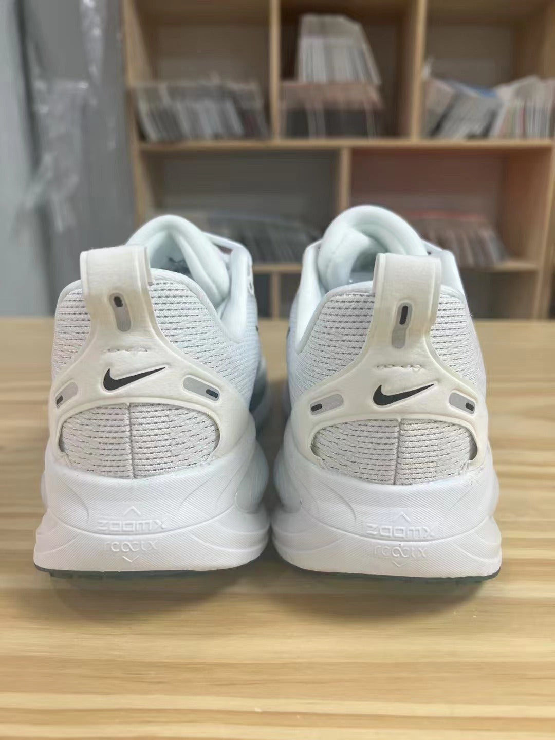 Nike Vomero 18 Shoes for Running, White with Dark Swoosh - product image from the listing.