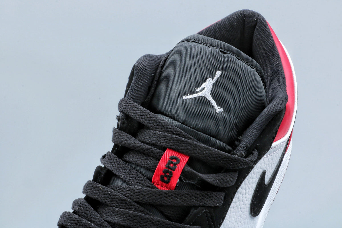 Jordan 1 Low Black Toe Sneakers in Black White Red - product image from the listing.