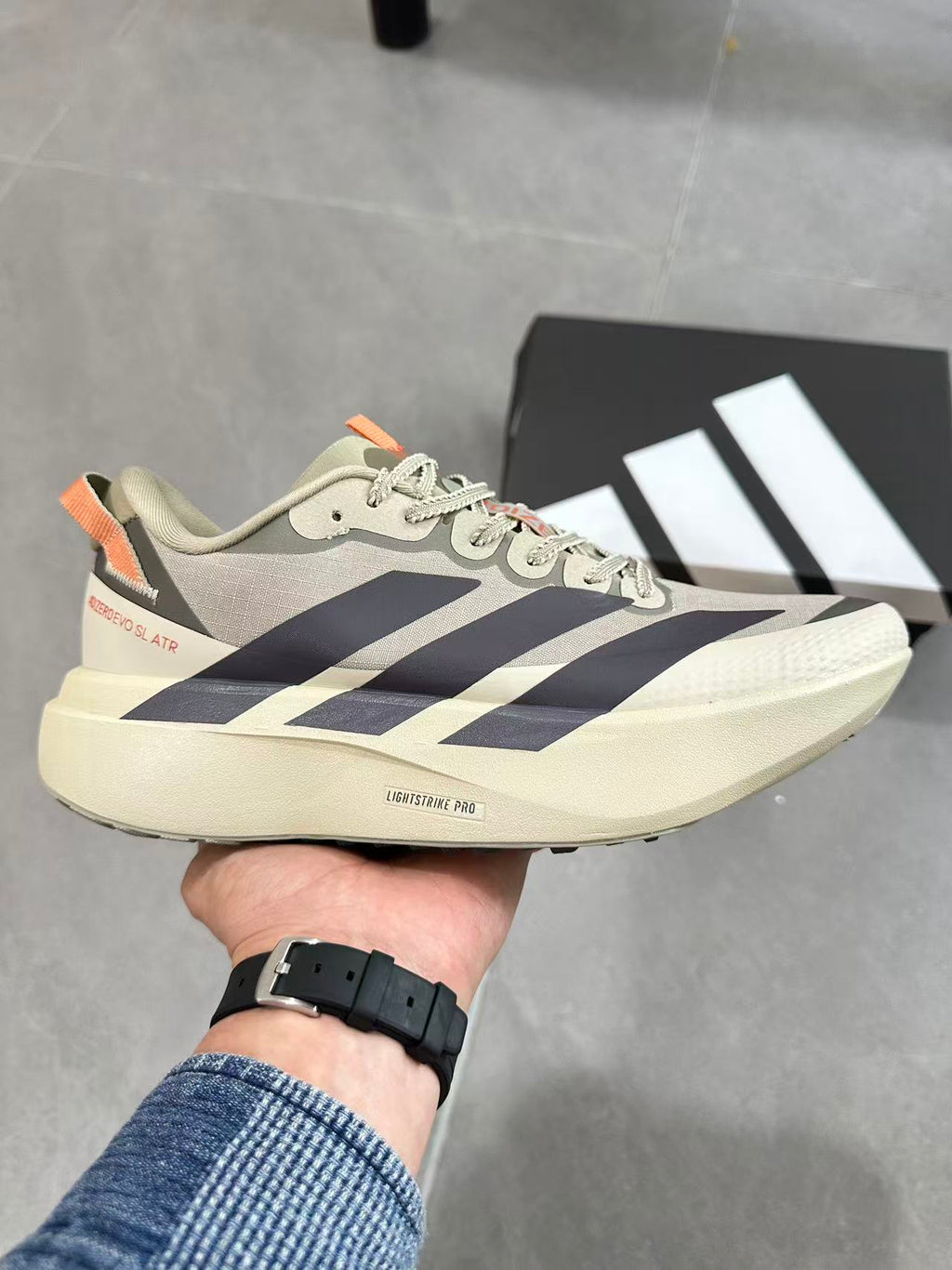 Adidas Adizero Lightstrike Pro Running Shoes, in Cream and Navy - product image from the listing.