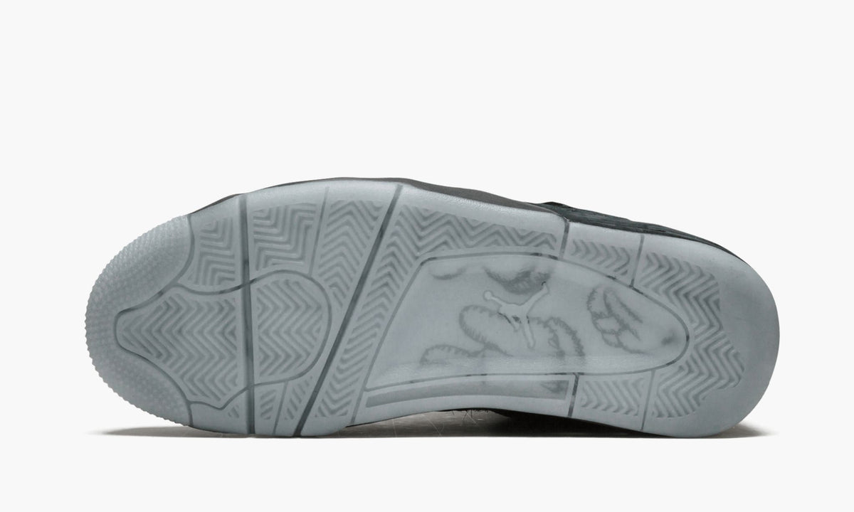 Air Jordan 4 Retro Kaws in Black - product image from the listing.