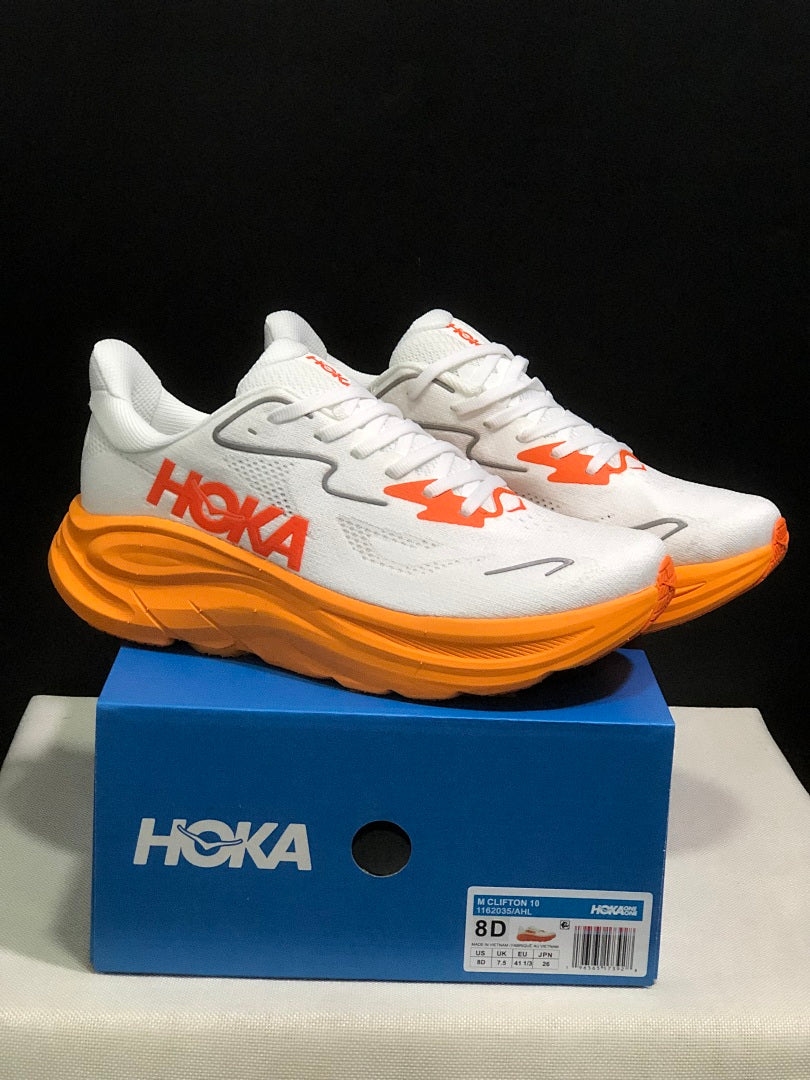 White and Orange HOKA Clifton 10 Running Shoes - product image from the listing.