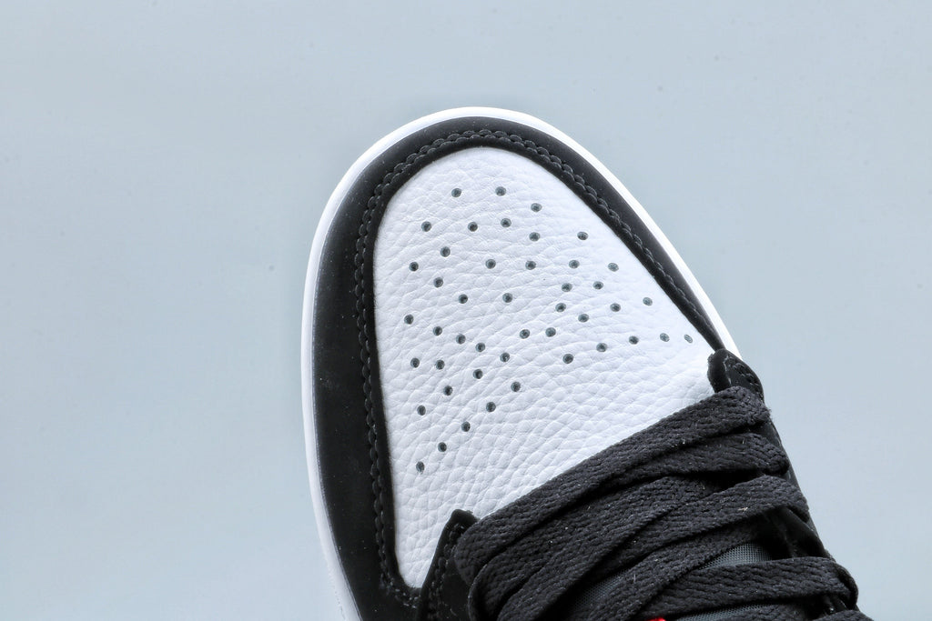 Jordan 1 Low Black Toe Sneakers in Black White Red - product image from the listing.