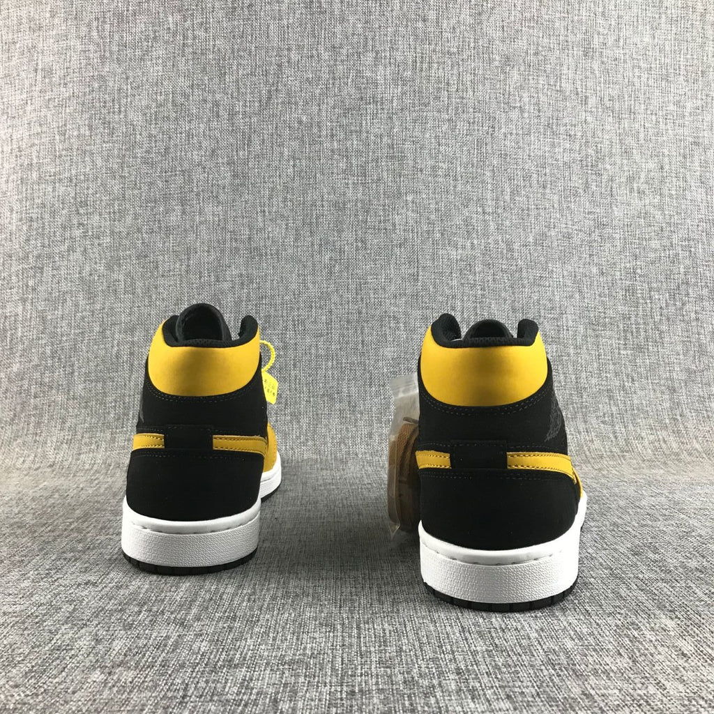 Air Jordan 1 Mid Sneakers in Black and Yellow - product image from the listing.