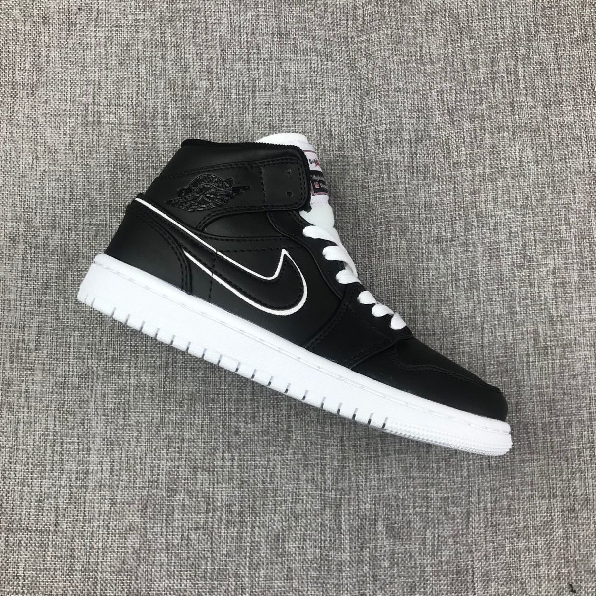Air Jordan 1 Mid Sneakers in Black and White 852542-016 - product image from the listing.
