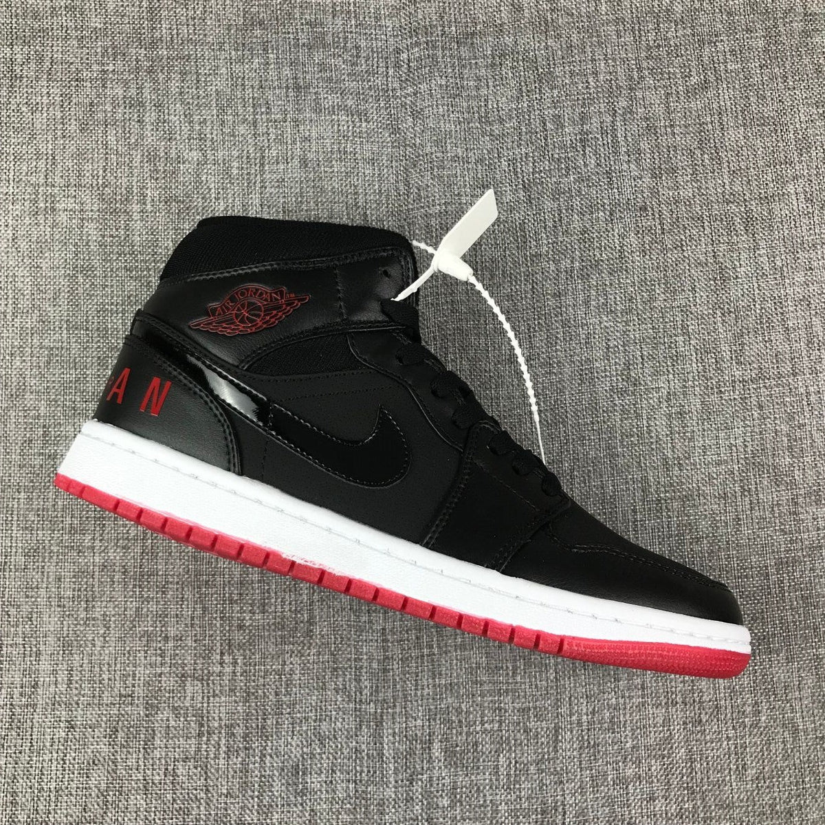Air Jordan 1 Mid High-Top Sneakers in Black Red White - product image from the listing.