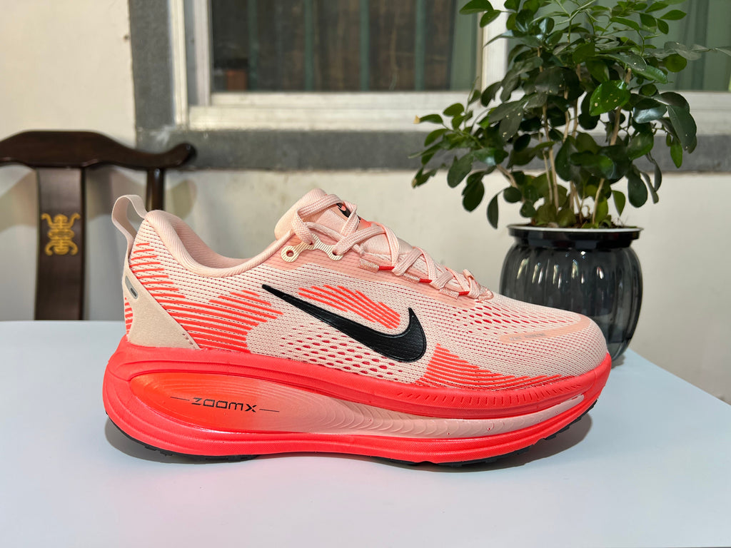 Cream and Coral Nike Vomero 18 Running Shoes - product image from the listing.