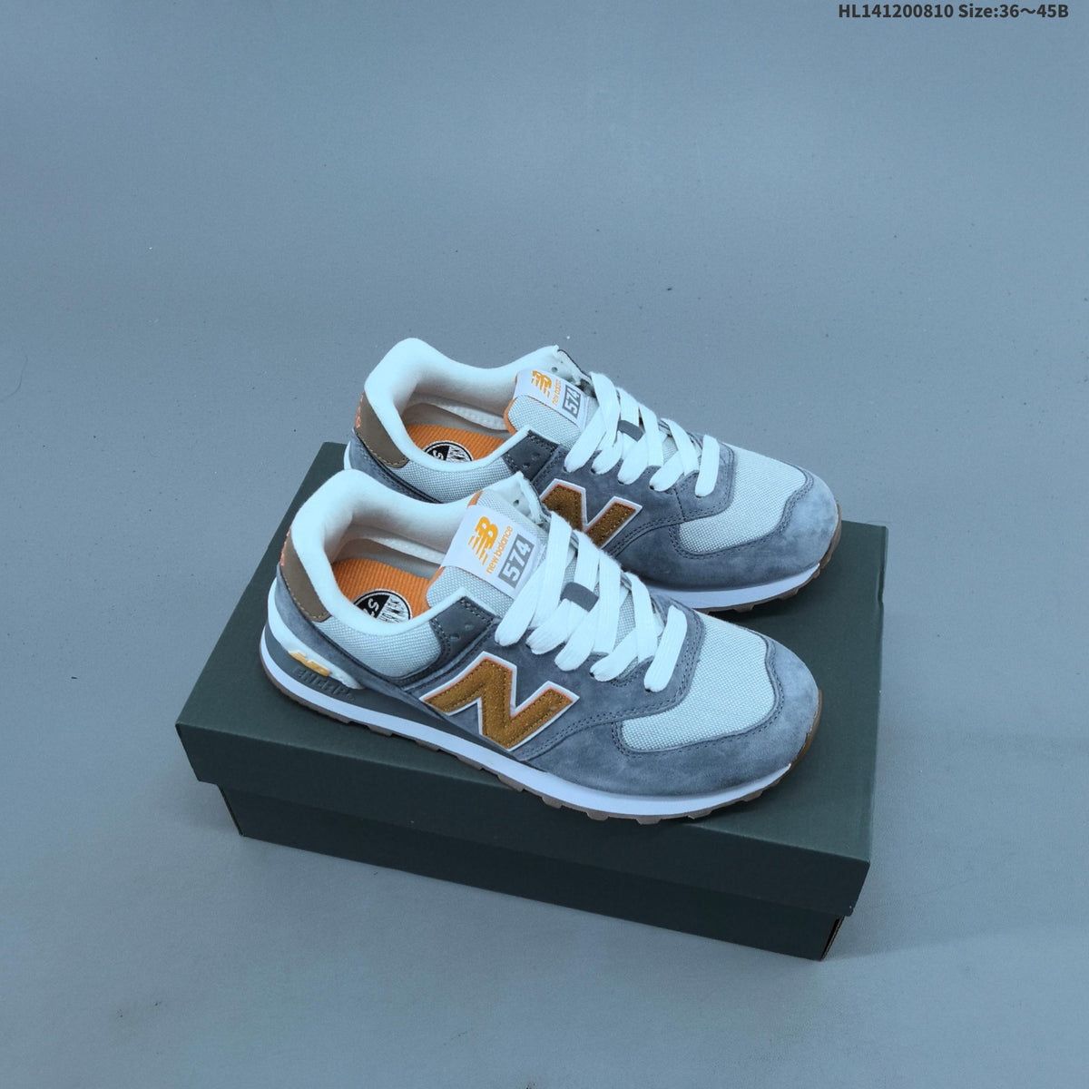 New Balance 574 Retro Sneakers in Black, Grey or in Cream - product image from the listing.