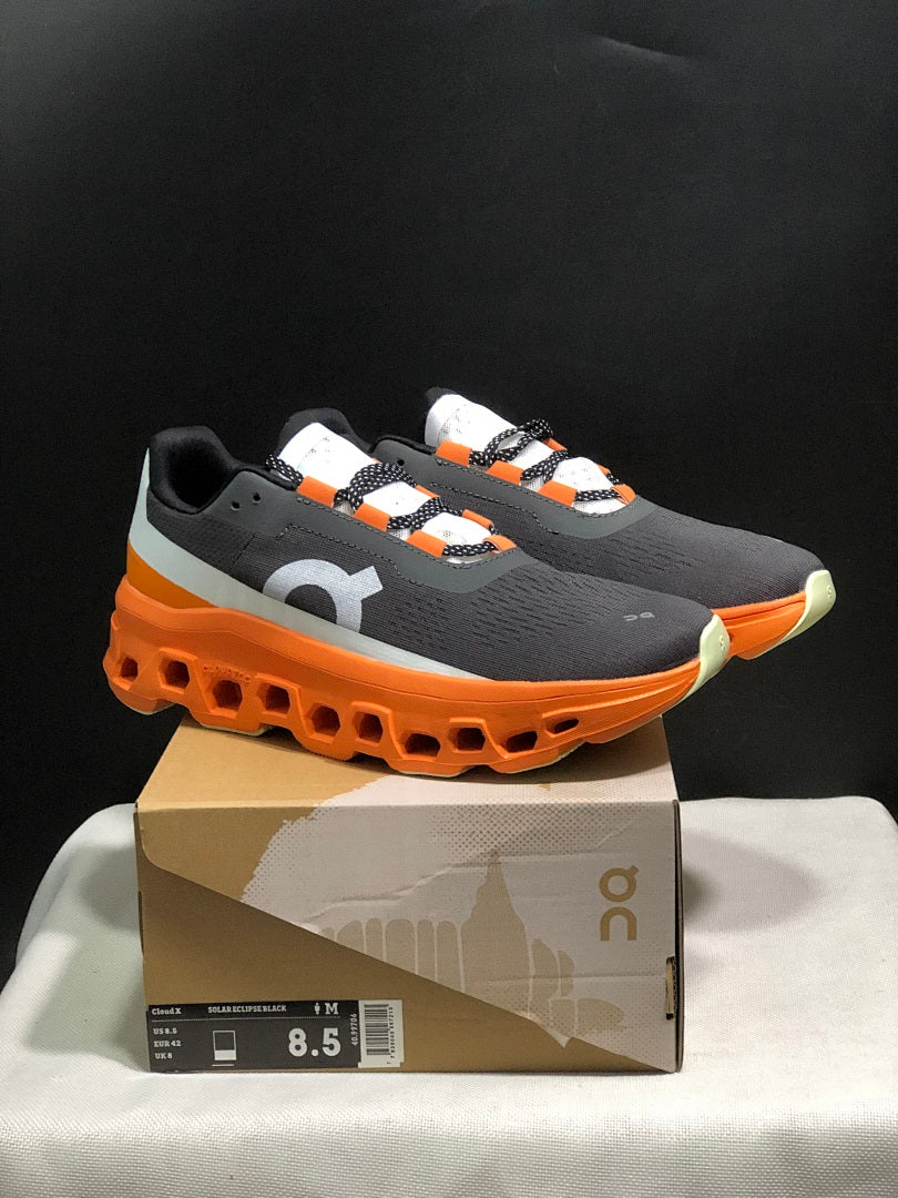 On Cloudmonster Running Shoes in Black Orange - product image from the listing.