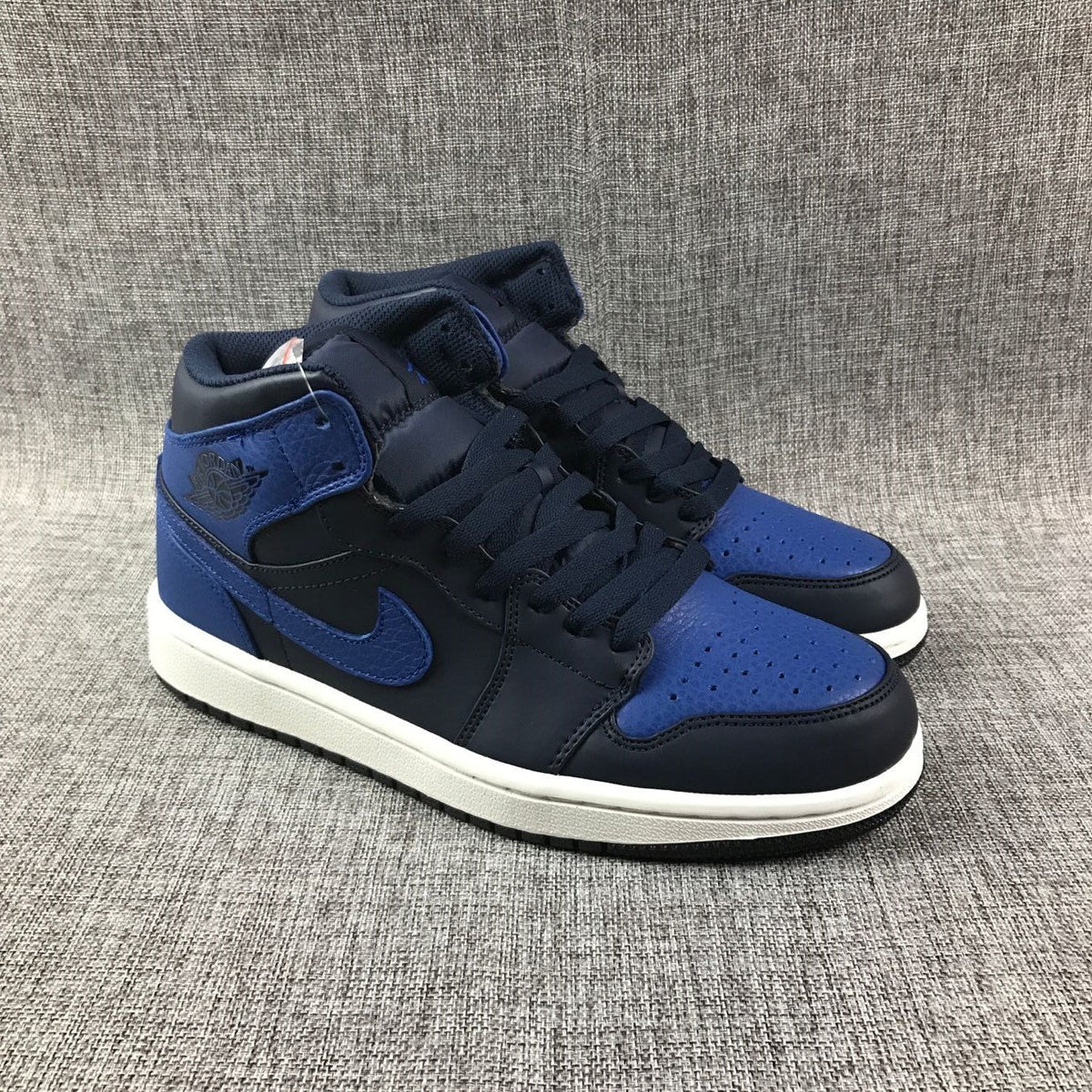 Air Jordan 1 Mid High-Top Sneakers in Black and Royal Blue - product image from the listing.
