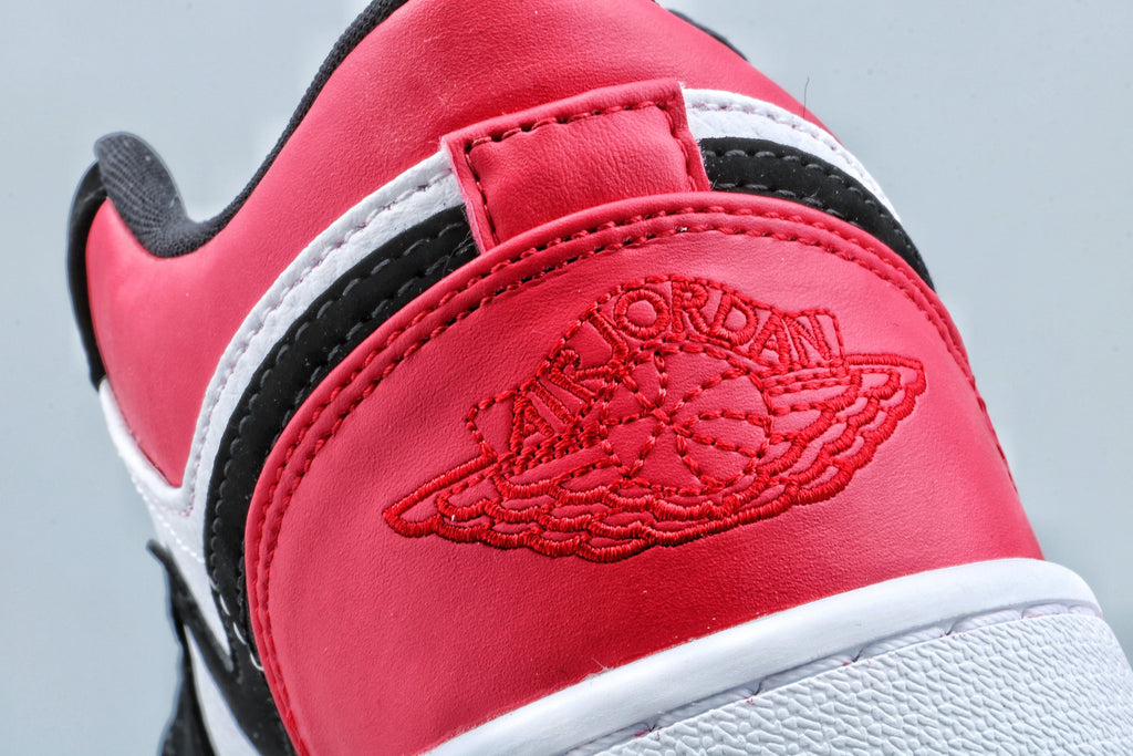 Jordan 1 Low Black Toe Sneakers in Black White Red - product image from the listing.