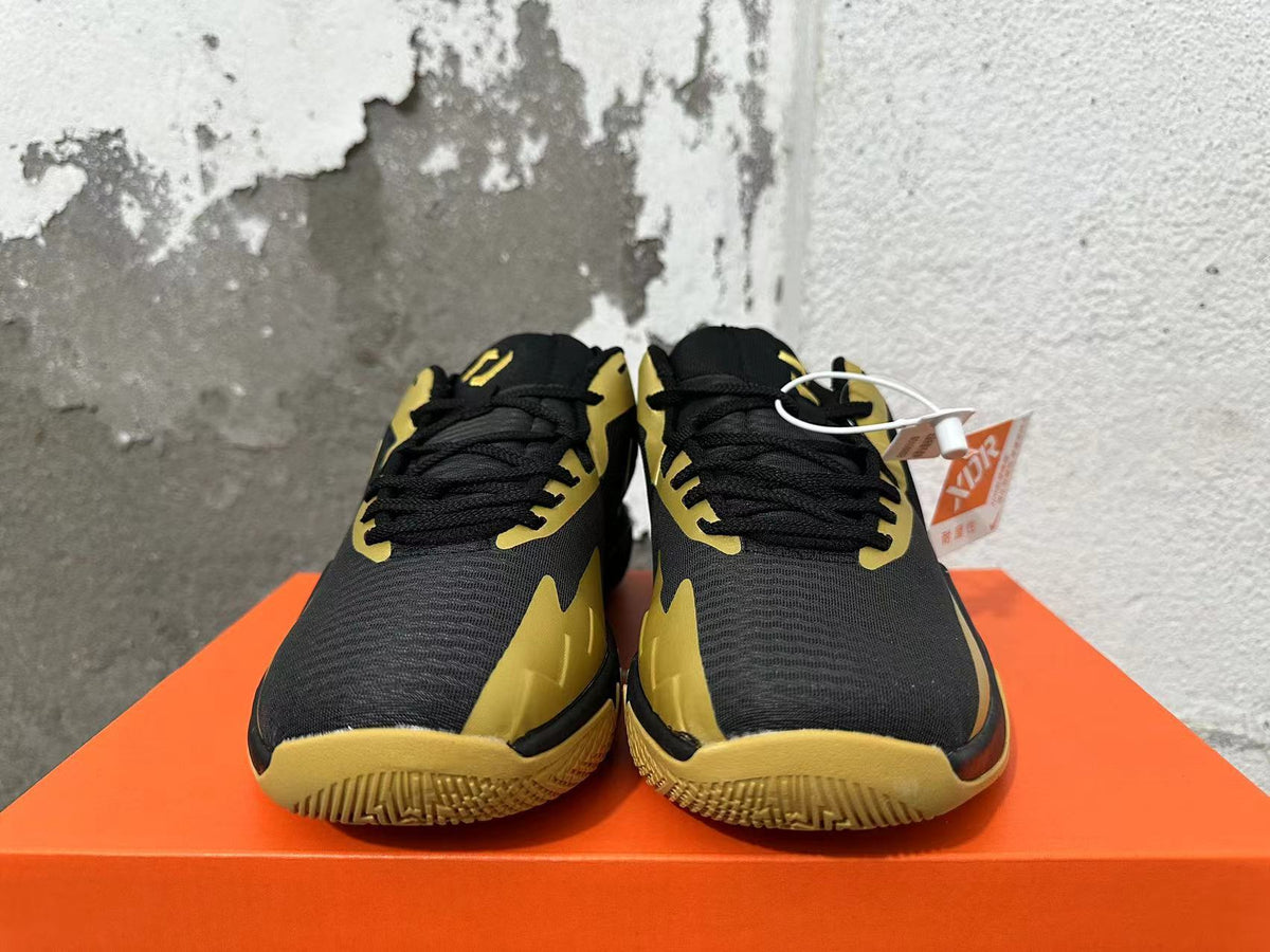 Nike Basketball Sneakers in Black and Gold - product image from the listing.