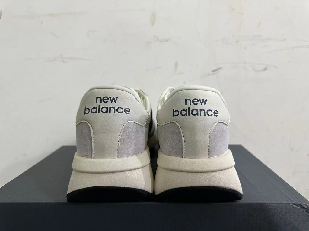 Gray and Navy New Balance U370 Sneakers - product image from the listing.