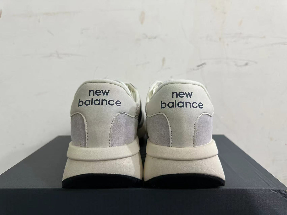 Gray and Navy New Balance U370 Sneakers - product image from the listing.