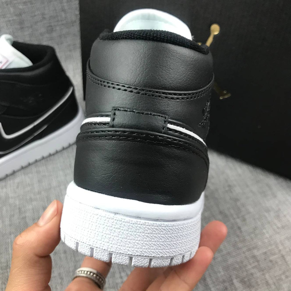 Air Jordan 1 Mid Sneakers in Black and White 852542-016 - product image from the listing.