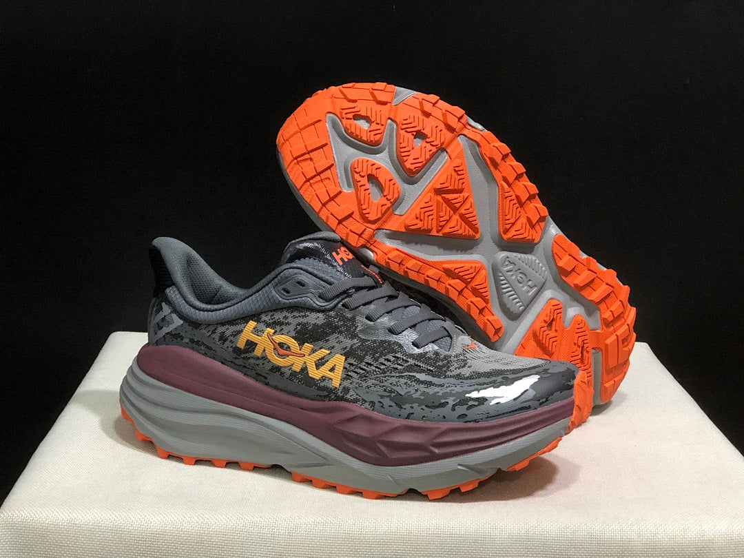 HOKA Stinson 7 Trail Running Shoes in Gray Orange - product image from the listing.