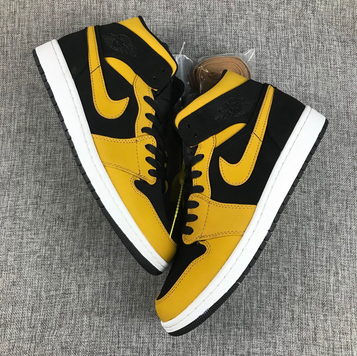 Air Jordan 1 Mid Sneakers in Black and Yellow - product image from the listing.