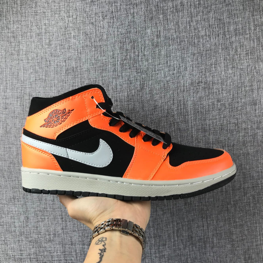 Air Jordan 1 Mid Sneakers in Black Orange 554724-062 - product image from the listing.