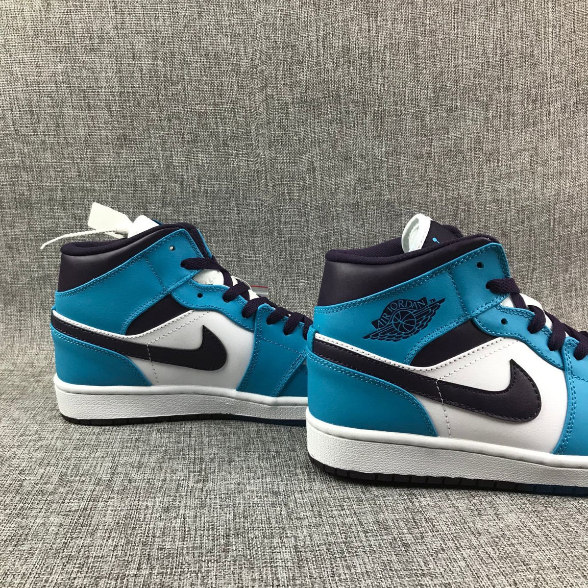Air Jordan 1 Mid Sneakers in Blue, in White and Black - product image from the listing.