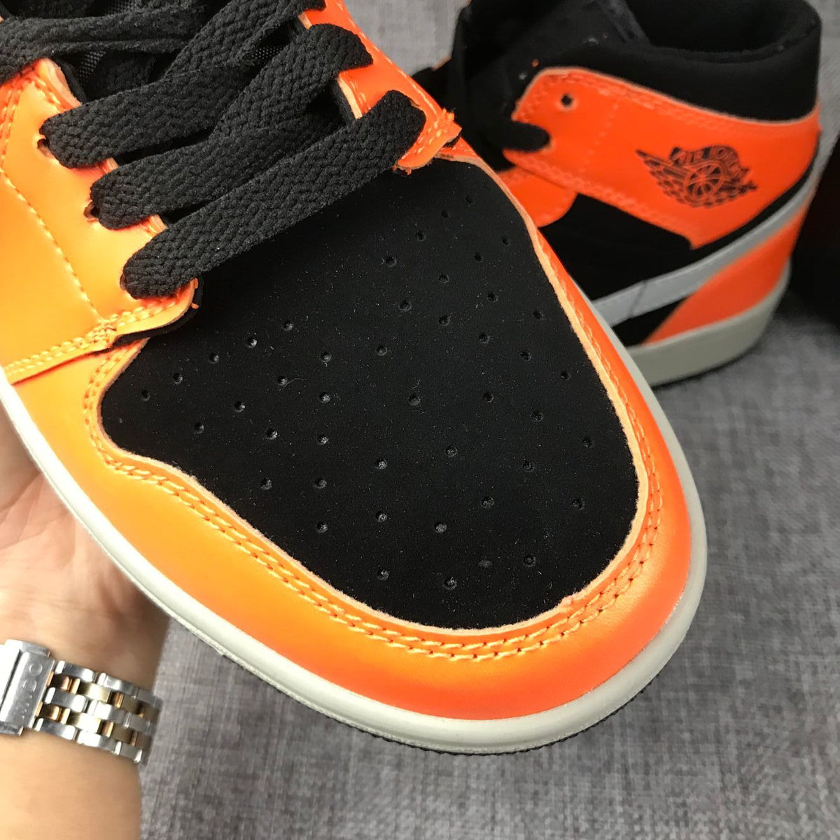 Air Jordan 1 Mid Sneakers in Black Orange 554724-062 - product image from the listing.