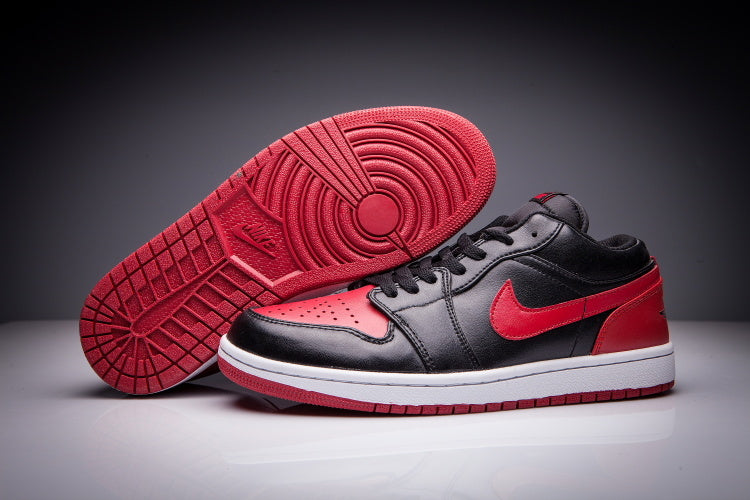 Jordan 1 Low Sneakers in Black and Red - product image from the listing.